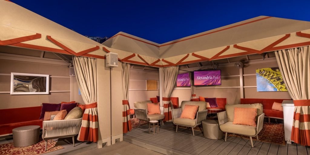 Cabana at Alexandria Pool with televisions, couch, and various seating