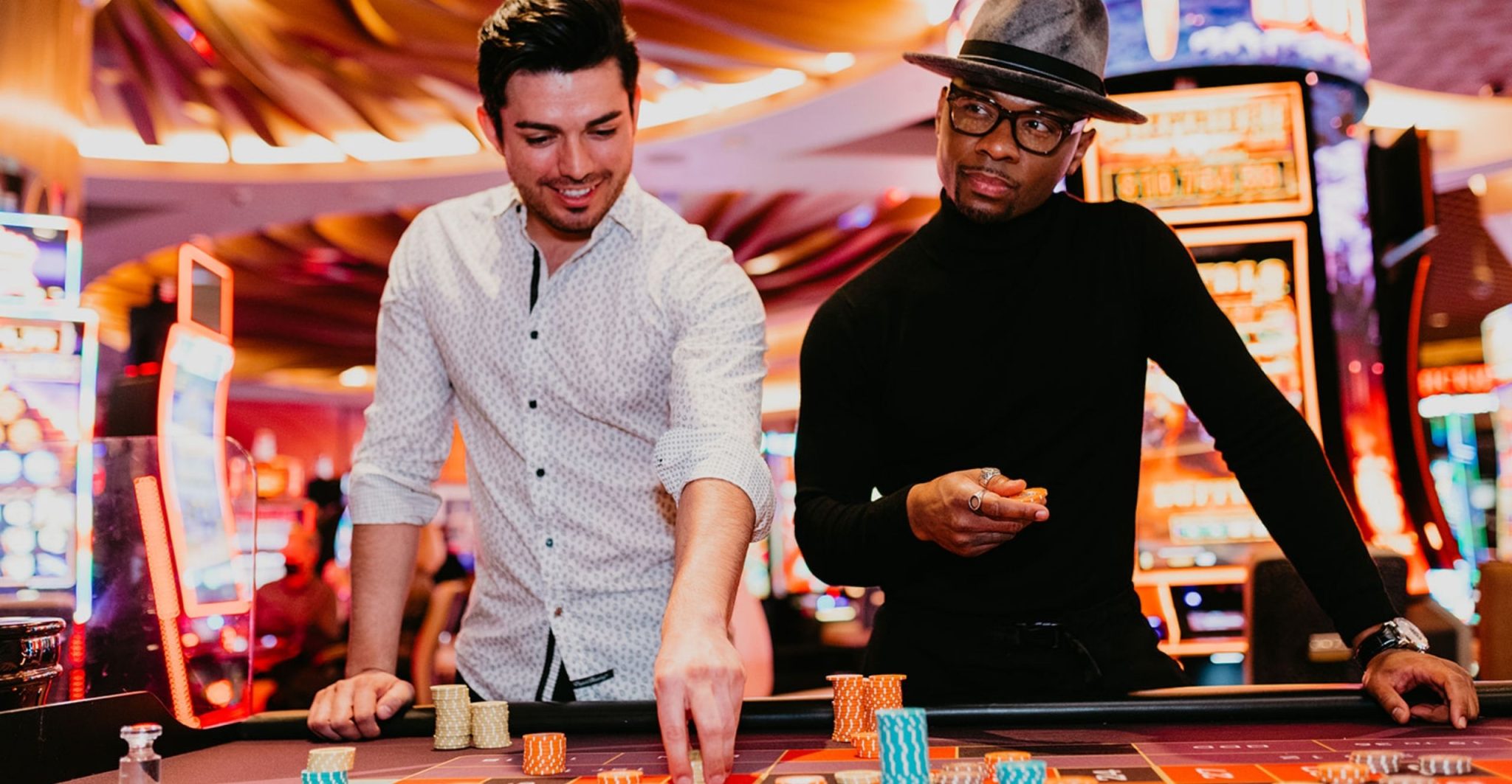 Two men playing table games in the casino.