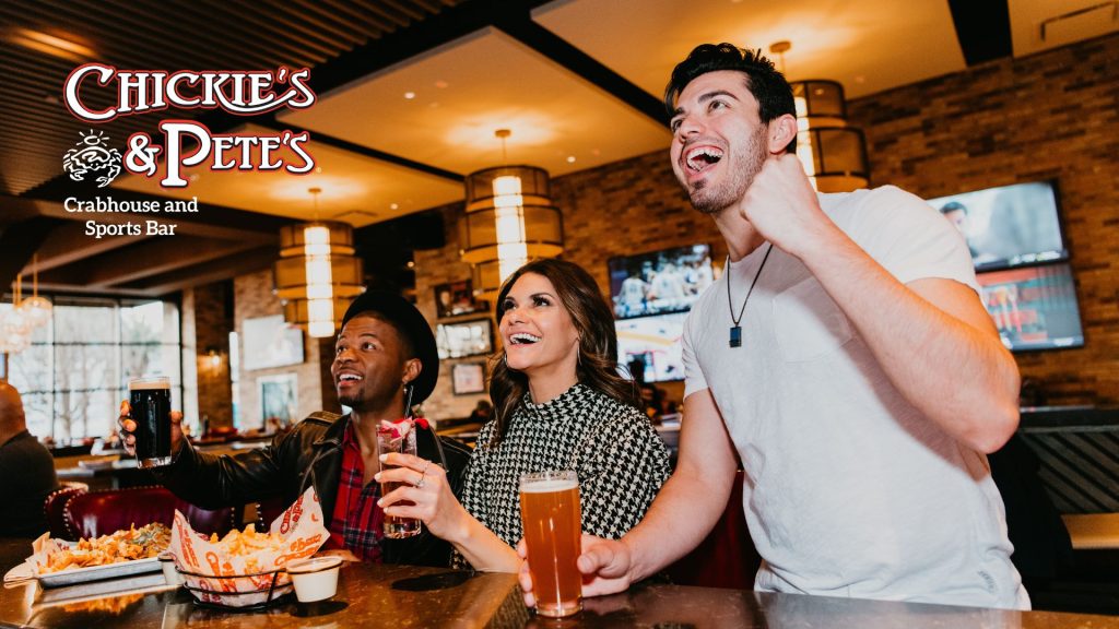 Friends rooting for the sports team on tv at Chickie's & pete's