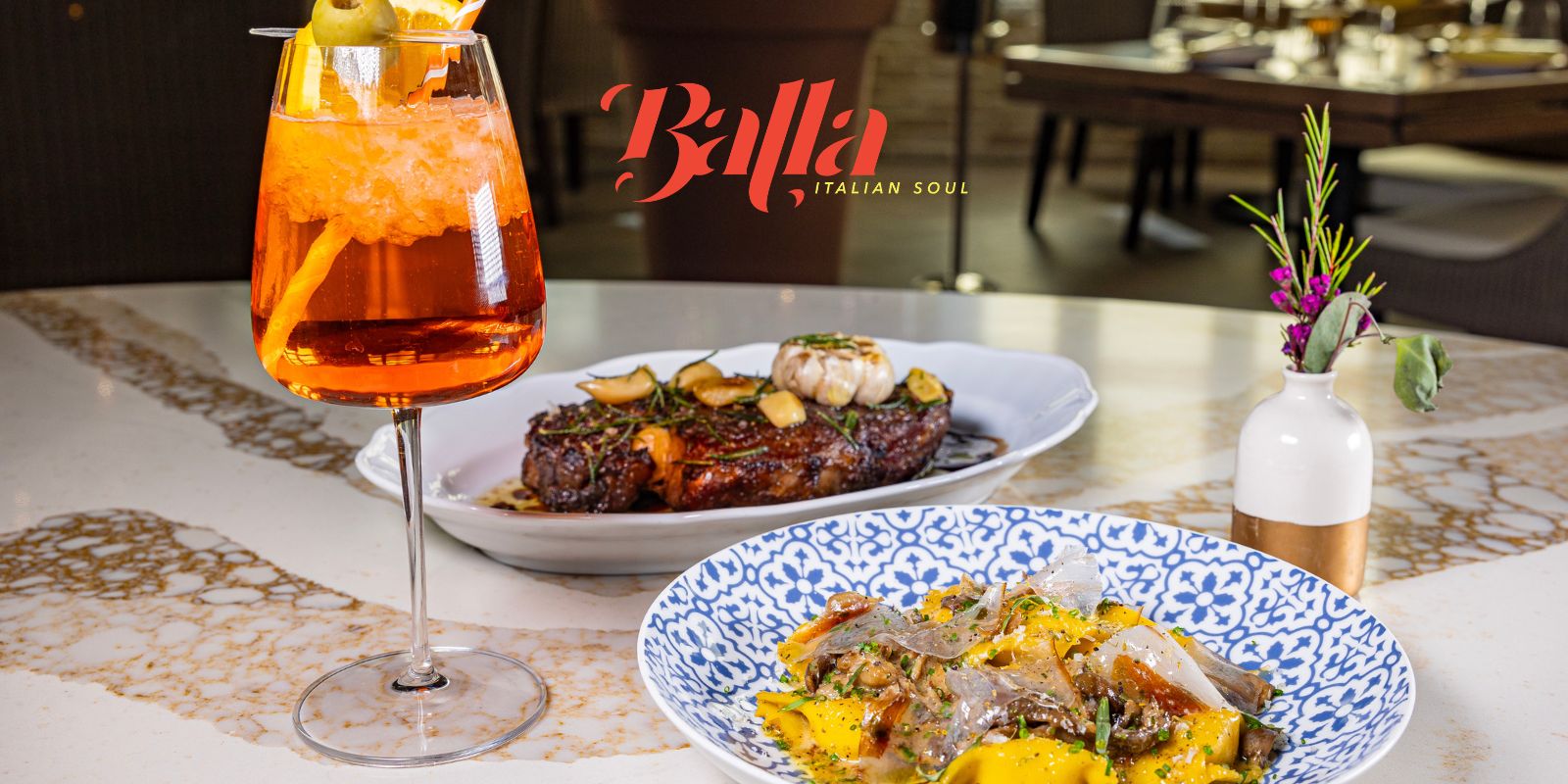 Balla New Hero Shot - July, 11 2023 - picture of a steak, pasta, and an Aperol Spritz