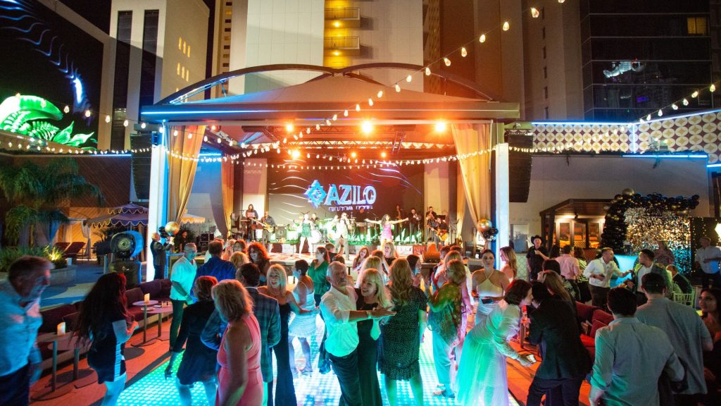 An outdoor event full of guests dancing out by AZILO Ultra Pool