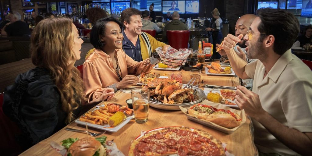 Friends eating and drinking at Chickie's & Pete's.