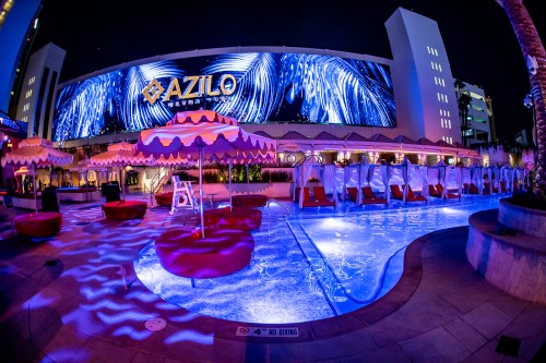 night time shot of AZILO ultra pool with large LED video wall as feature