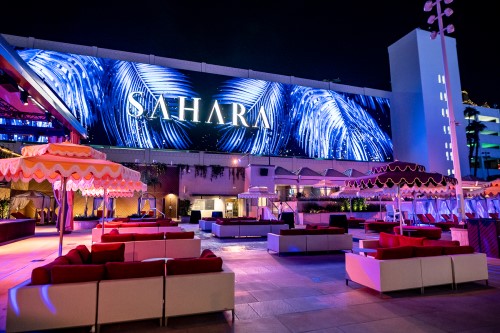 night time shot of AZILO ultra pool with large LED video wall as feature