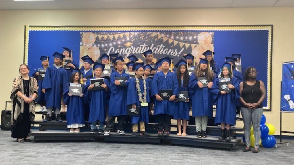Robert E. Lake 5th grade graduation class. Students dressed in caps and gowns.