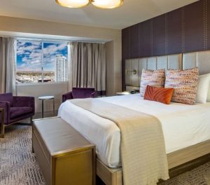 picture of a marra style room with a king bed and a view out the window of Vegas